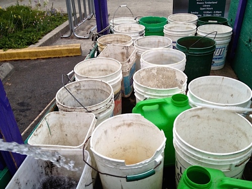 Allan's photo: filling buckets at the community building. (The boatyard water was turned off.)